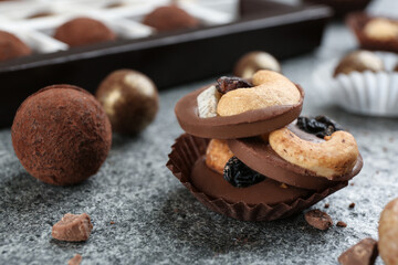 Different delicious chocolate candies on grey table, closeup