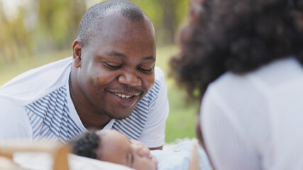 African American family Parents take care of cute baby in garden of house. Happy baby daughter. Father and mother Smile feel relax in playing with children. Concept Family health care insurance