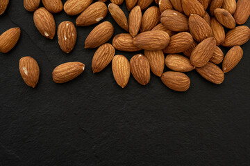 almond on black background. Top view. Flat lay (selective focus; close-up shot)
