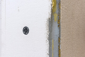 Wall of bricks and insulation materials under construction.