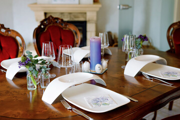 Elegant decorated table for dinner with family or friends. Fine dining at home during corona virus quarantine lockdown.