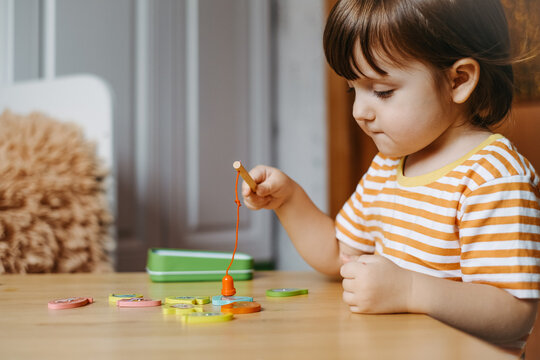 Early Baby Development. Homeschooling A Young Autistic Child. The Kid Learns To Play The Game Of Fishing.