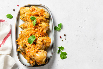 Oven baked chicken stew on a dish. Space for text, top view.