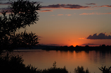 Fototapeta na wymiar Sunset. Orange sky. Reflection in the river. Horizon