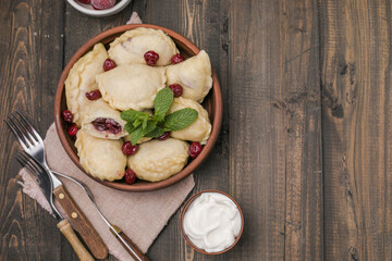 Pierogi with cherries. Vareniki dumplings. Traditional Ukrainian food. Cooked and served with sour...