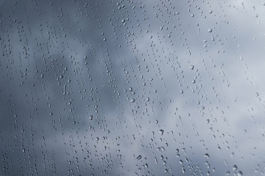 Water drops on window glass, closeup. Rainy weather
