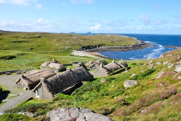 Garenin blackhouse village on the west coast of the Isle of Lewis in the Outer Hebrides of Scotland, UK on a beautiful sunny day with a view of a Garenin bay © Nigar