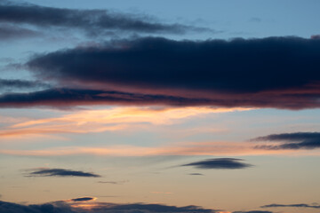 Cloud formation in warm colors at dusk. Shot in Sweden, Scandinavia.
