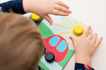 Home made infant toddler game. bottle cups needs to screw in correct location. traffic light, car wheels and sun.
