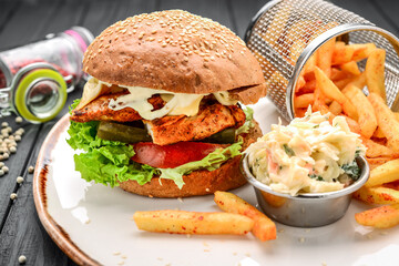 Chicken burger with potatoes and cabbage salad