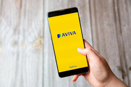 03-22-2021 Portsmouth, Hampshire, UK A mobile phone or cell phone being held in a hand with the AVIVA app open on screen