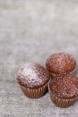 three muffins cupcakes covered in powdered sugar. bakery sweet