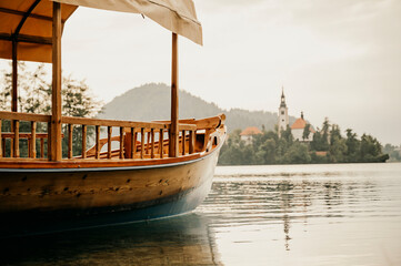 Lake Bled Slovenia. Beautiful mountain lake with small Pilgrimage Church. Traditional wooden boats...