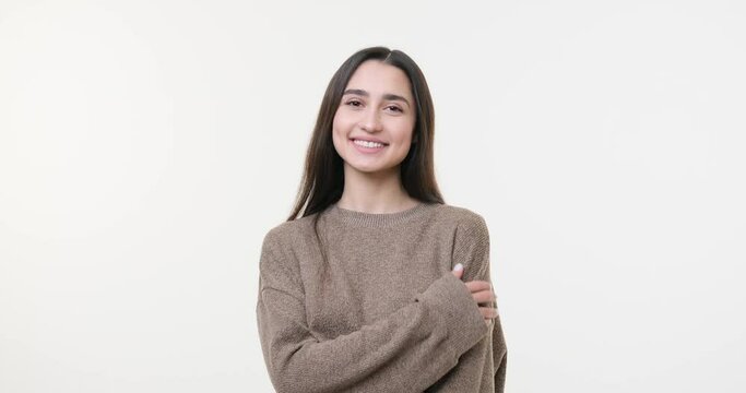 Happy woman with arms crossed over white background