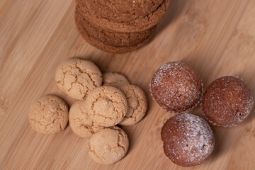 muffins, almond amaretti and oat cookies on wooden stand board. sweet bakery concept