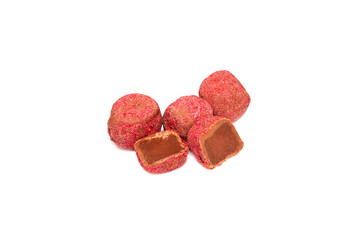 Chocolate truffles with raspberry closeup isolated on white.