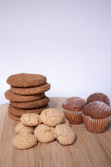 muffins, almond amaretti and oat cookies on wooden stand board. sweet bakery concept