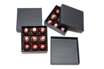 Chocolate candies in giftboxes isolated on white background. Assorted chocolates confectionery in their gift boxes. Set of colorful chocolate bonbons.