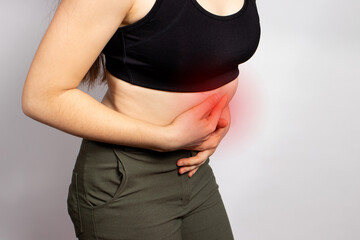 A woman's stomach hurts. Abdominal pain due to gastritis, stomach ulcers and Crohn's disease....