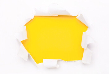 Torn white paper lies on a bright yellow background. Template. Copy space