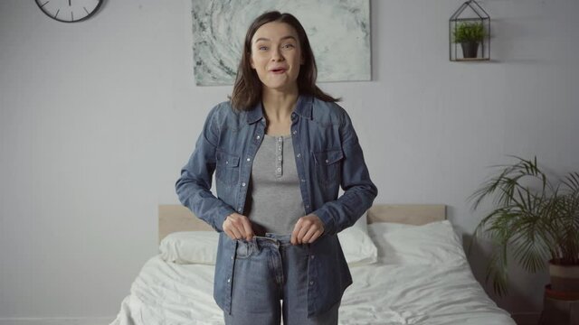 cheerful and woman wearing jeans after loosing weight