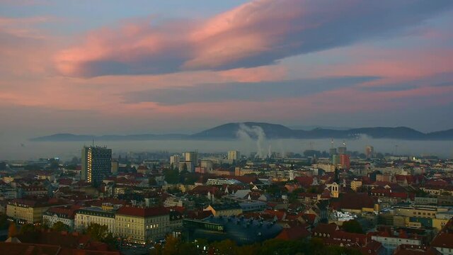 Cityscape of Graz from Schlossberg hill with historic and modern buildings, in Styria region, Austria, in the morning at sunrise
