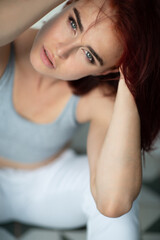 Beautiful young ginger woman with freckles. Fashion portrait of charming girl wearing casual...