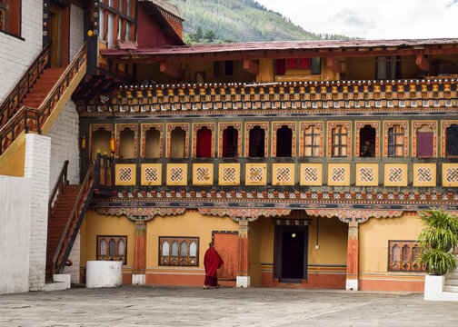 A monk in front of one of the buildings in Tashichho Dzong. Thimphu, Bhutan.