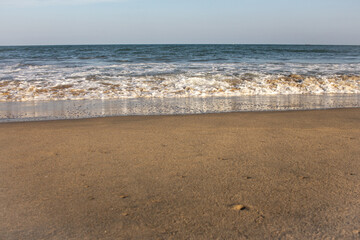 Beautiful view of waves along the beach in coastal town of Mahabalipuram, India
