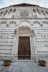 Cityscape. View of Carrara cathedral, in Tuscany, Italy, a church entirely build with white marble. Close up of entrance