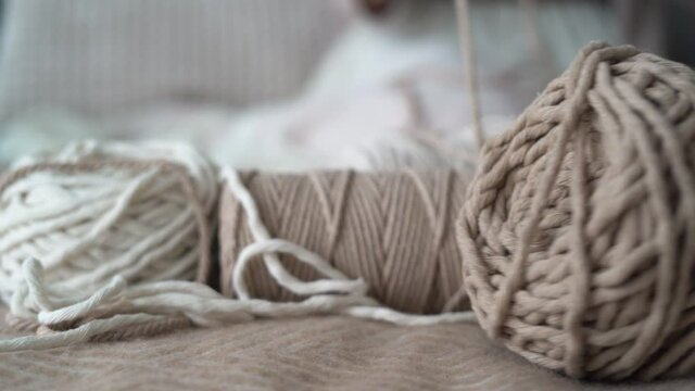rope for macrame. Woman's hand lay down a ball of thread. Female hobby concept. Copy space. close-up. 4k