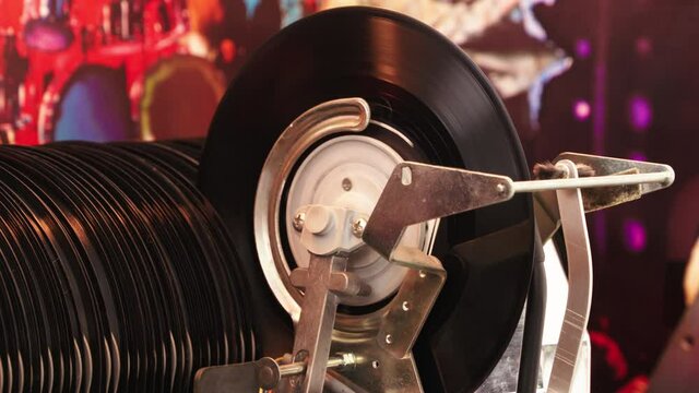 Fine shot Jukebox playing music from vinyl single record with old time classic mechanism. 