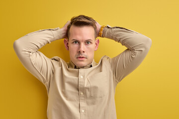 frustrated confused man nervous about something on yellow