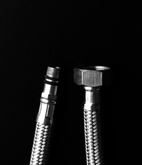 Flexible water hose on a black background