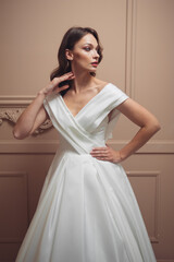 Fototapeta premium Beautiful bridesmaid dress earrings. Beautiful bride with stylish makeup and hairstyle.
