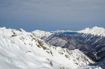 Fototapeta na wymiar View from the peak of the mountains in the ski resort Rosa Khutor Russia