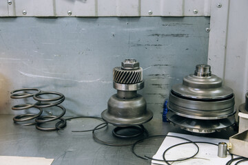 Set of various engine and gearbox spare parts. Shiny gears for planetary gearbox.Metal autotechnology background. wheel engine gears, close up. Automatic transmission in section