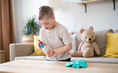 Down syndrome child cleaning at home, help with housework.