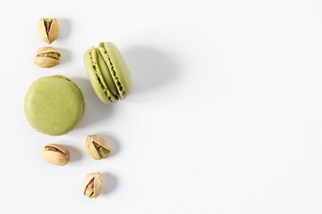 Pistachio macaroons dessert on white background top view.