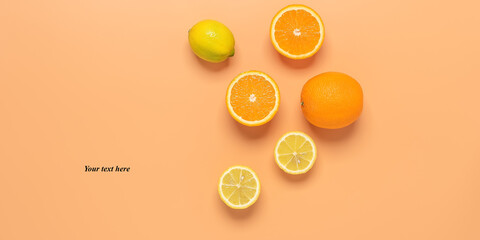 Fresh orange and lemon on a pastel yellow background. Top view, flat lay, banner. Summer tropical background.