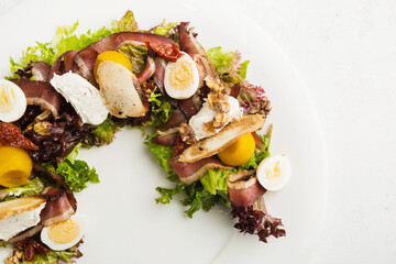 salad of green leaves, bacon and eggs