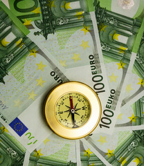 golden Compass lie in the center on 100 hundret euro bill background