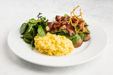 breakfast of fresh salad and scrambled eggs
