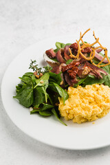 breakfast of fresh salad and scrambled eggs