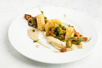 fish cakes with vegetable garnish and mashed potatoes