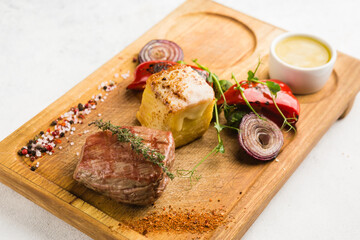 restaurant dish with grilled meat and vegetable side dish