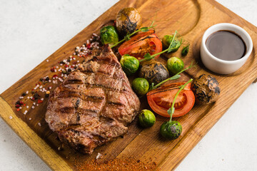 restaurant dish with grilled meat and vegetable side dish