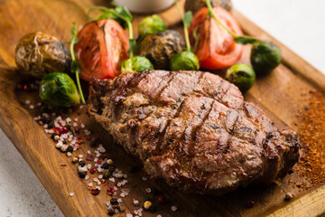 restaurant dish with grilled meat and vegetable side dish