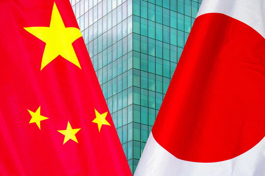 Flag of Japan and China flag close-up. The concept of political and economic relations of states