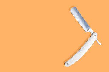 Straight metal razor with a wooden handle.